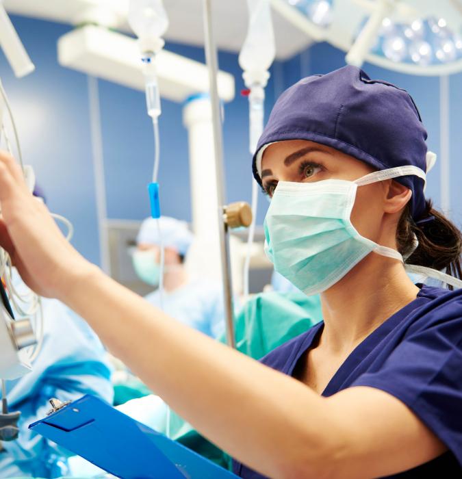 Nurse and hospital Caregivers work diligently to help a critical care patient. 